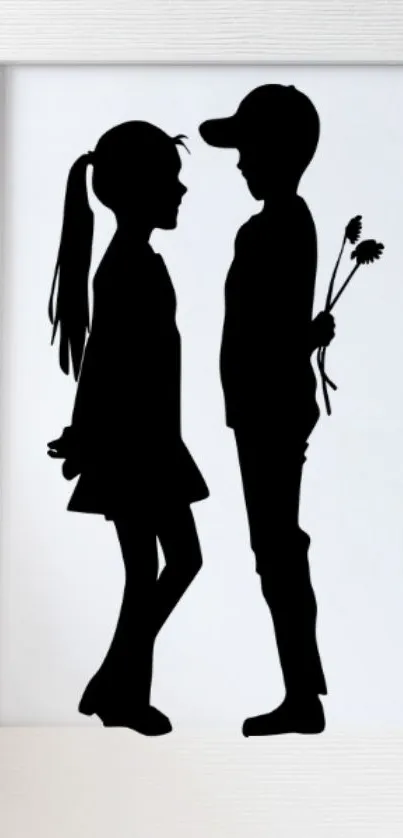 Silhouette of a boy and girl holding flowers in a frame.