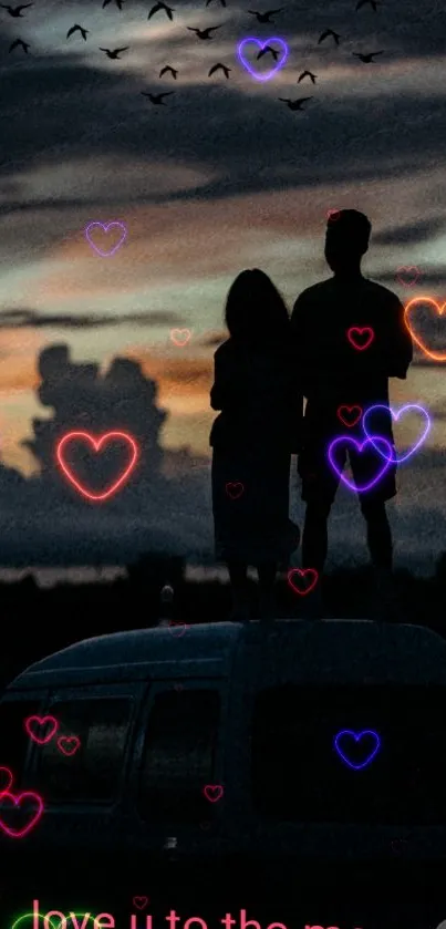 Silhouette of a couple with neon hearts against a twilight sky.