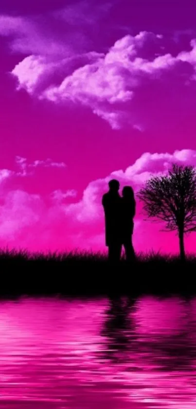 Romantic silhouette by a pink sunset with clouds and reflection.