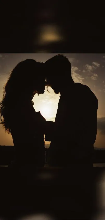 Silhouette of a couple at sunset with warm, romantic tones.