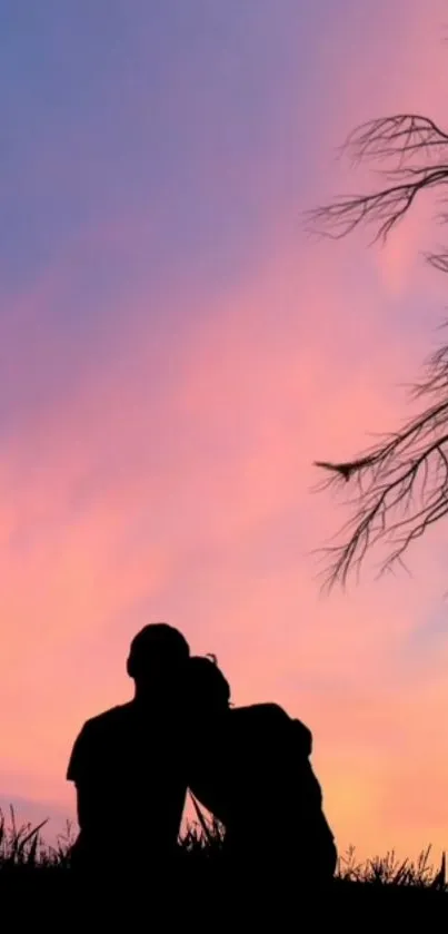 Silhouette of couple under pink and blue sunset sky.