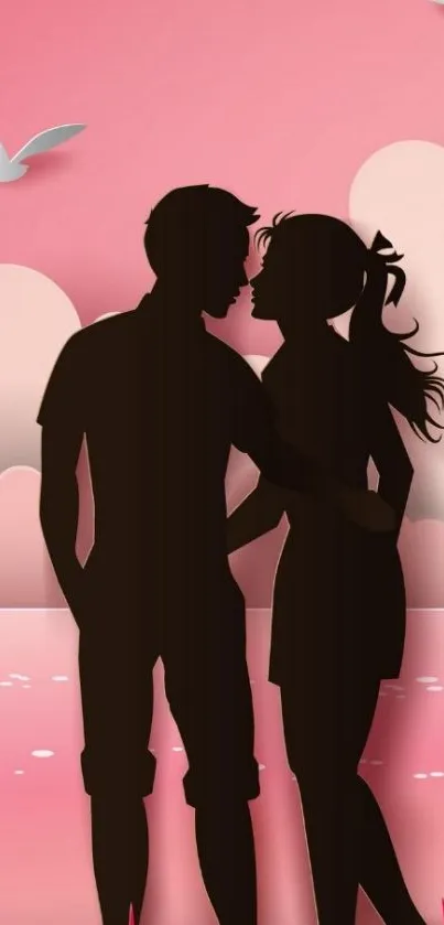 Romantic silhouette of a couple at sunset with pink hues.