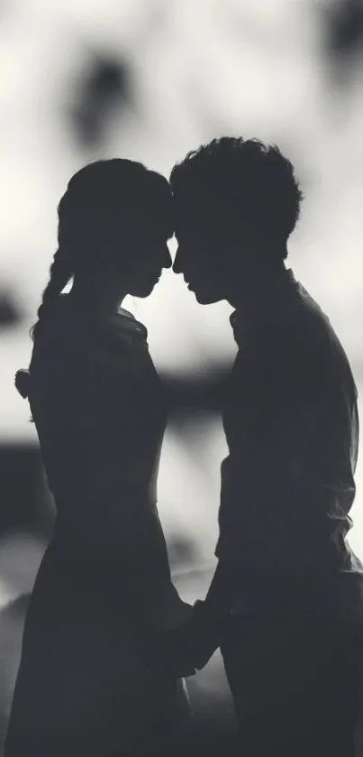 Romantic couple silhouette in grayscale wallpaper for mobile phone.