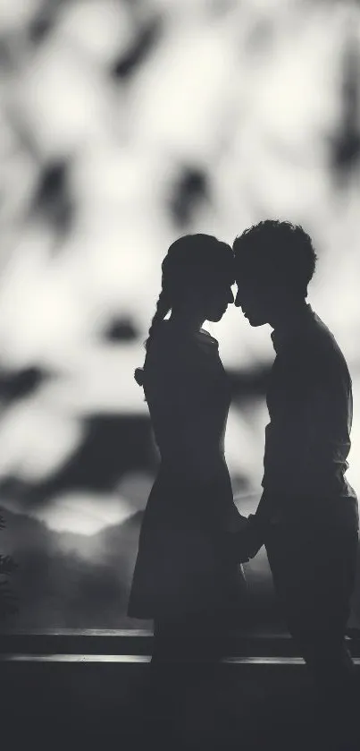 Silhouette of couple in romantic embrace.