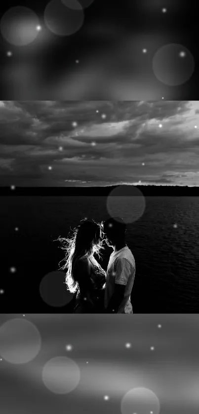 Silhouette of couple by water under starry sky.