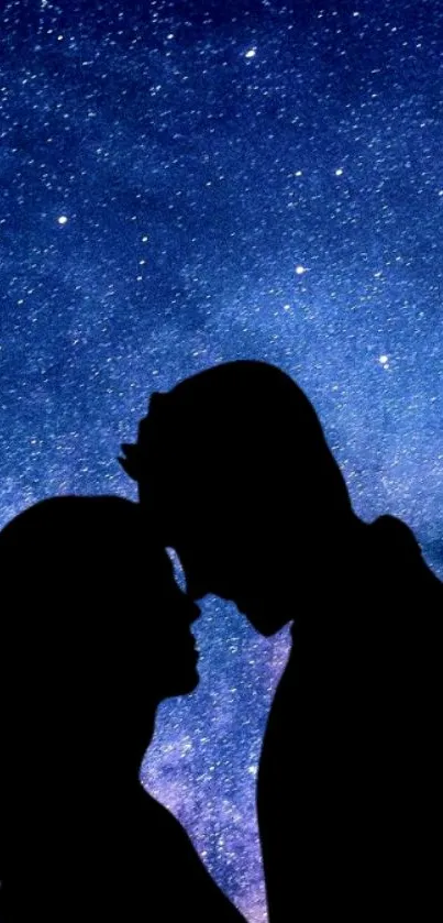 Silhouette of couple under starry night sky.