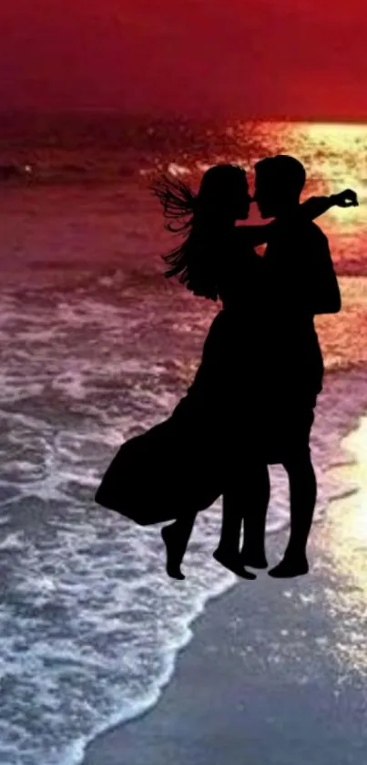 Silhouette of a couple embracing on a sunset beach.