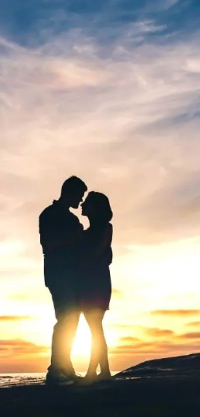 Silhouette of a couple embracing at a sunset beach.