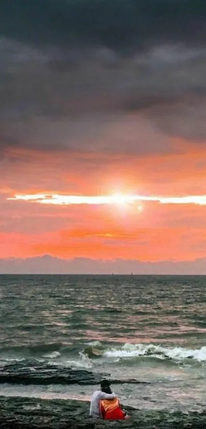 Romantic sunset on the beach with ocean waves and vivid sky hues.