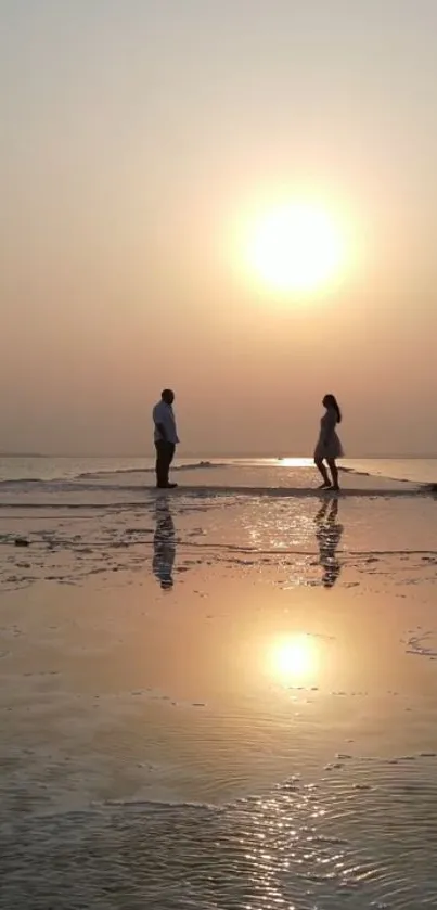 Romantic sunset beach scene with reflections.