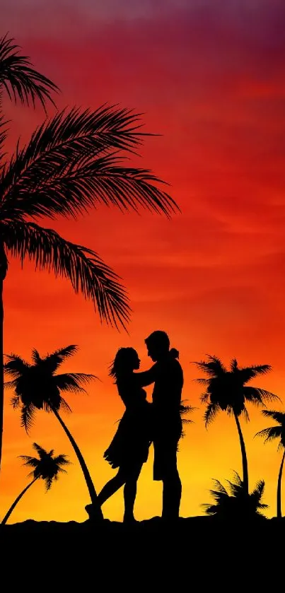 Silhouetted couple under palm trees at sunset with vibrant orange sky.