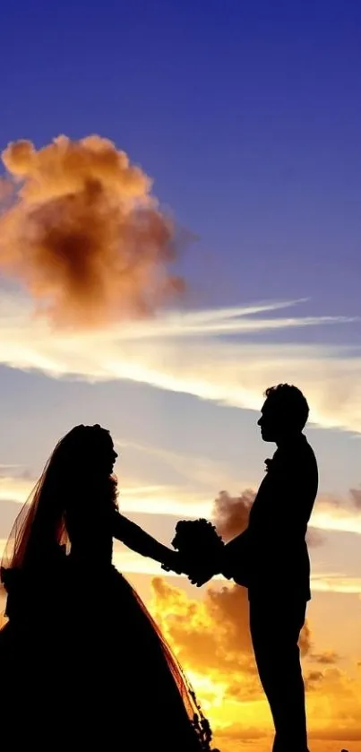 Silhouette of a romantic couple against a vibrant sunset sky.