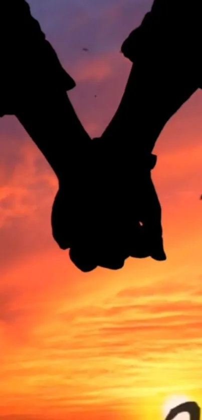 Silhouetted hands held against an orange sunset with birds flying.