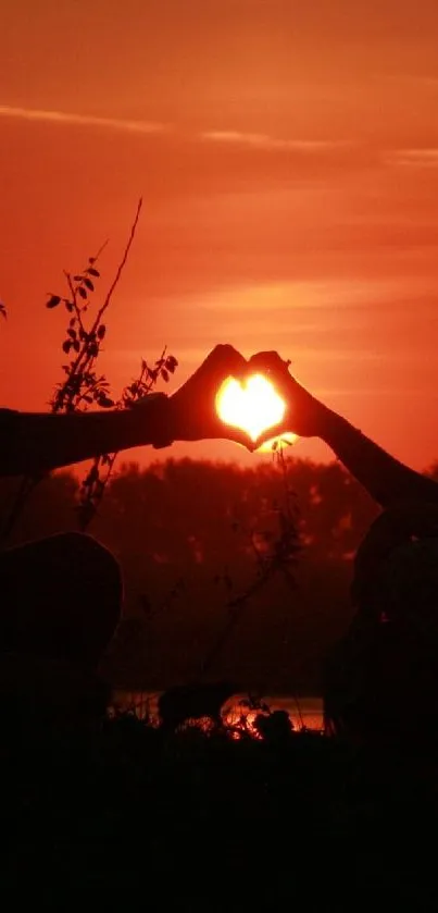 Romantic sunset with heart silhouette shapes in vibrant orange hues.