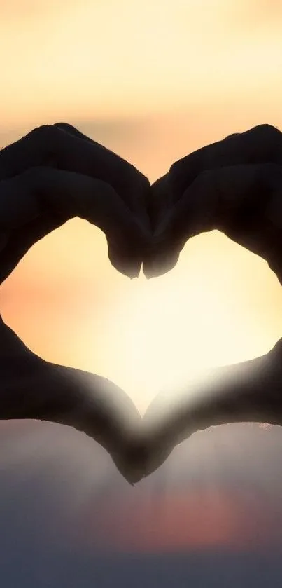 Heart-shaped silhouette at sunset with warm light glow.