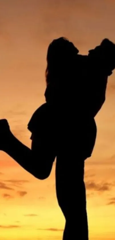 Silhouette of a couple embracing at sunset with an orange sky background.