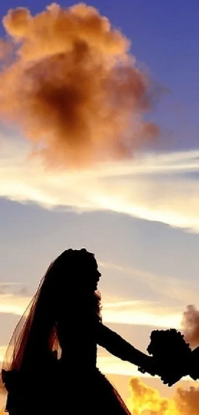 Silhouetted couple holding hands against a dramatic sunset sky.