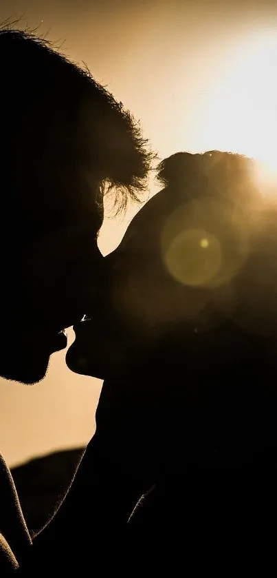 Silhouette of a couple kissing at sunset, with a warm and romantic glow.