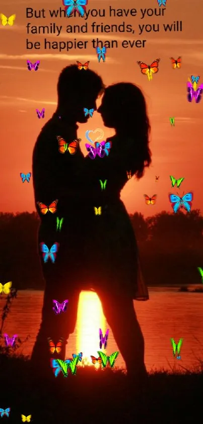 Silhouette of couple with colorful butterflies at sunset.