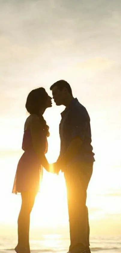 Silhouetted couple kissing at sunset on a scenic hill.