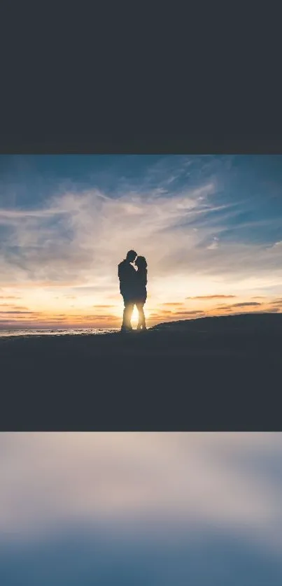 Silhouette of a couple embracing at sunset over a scenic landscape.