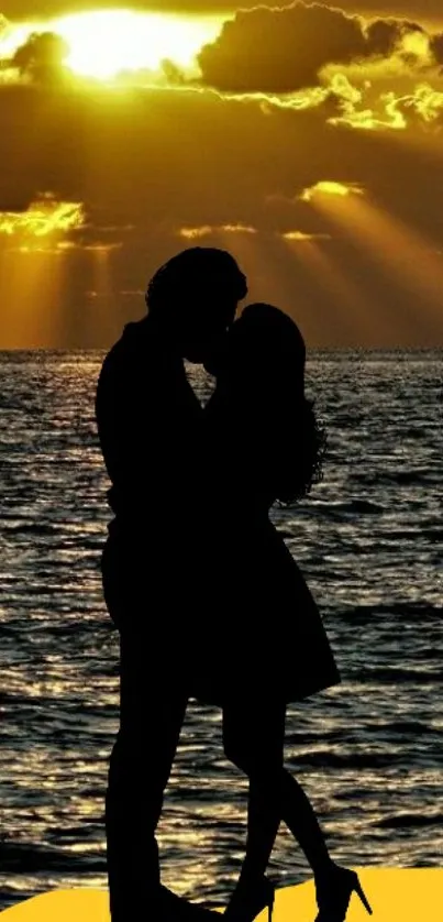 Silhouette of a couple kissing with a golden sunset in the background.