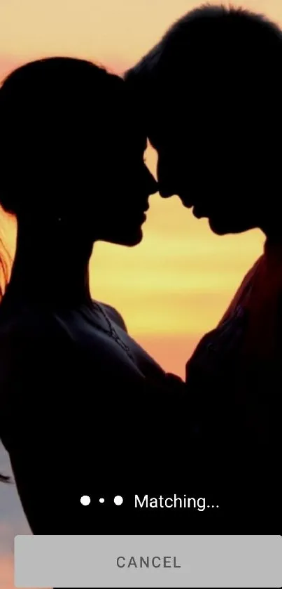 Romantic silhouette of a couple against a vivid orange sunset sky.