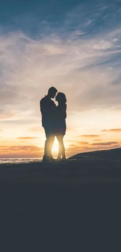 Silhouette of a couple at sunset by the ocean.