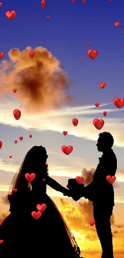 Silhouette of a couple holding hands at sunset with vibrant sky.