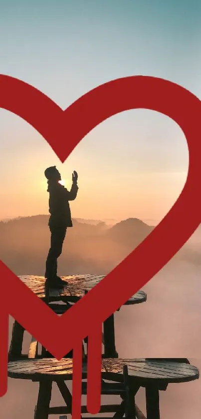 Silhouette on platform with heart at sunset.