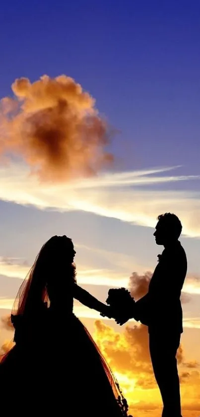 Silhouette of a couple holding hands at sunset with vibrant sky colors.