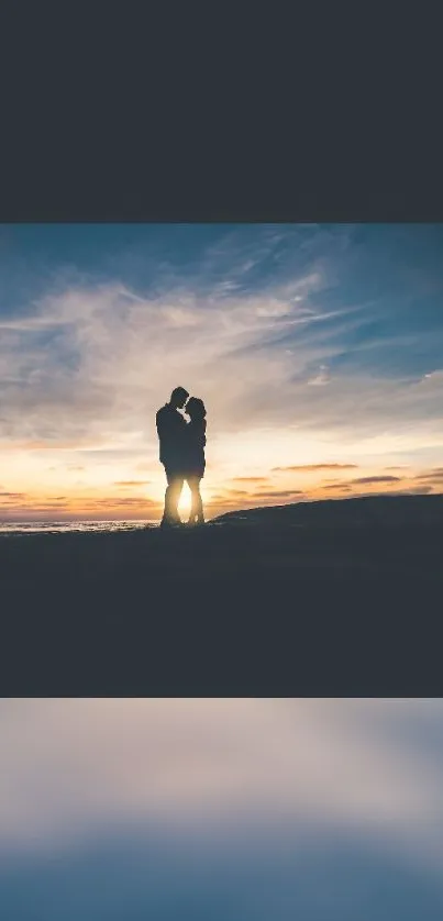 A couple silhouette against a sunset, offering a romantic and serene seaside view.