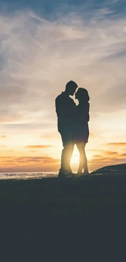 Silhouette of a couple embracing at sunset on the beach, with a romantic sky.