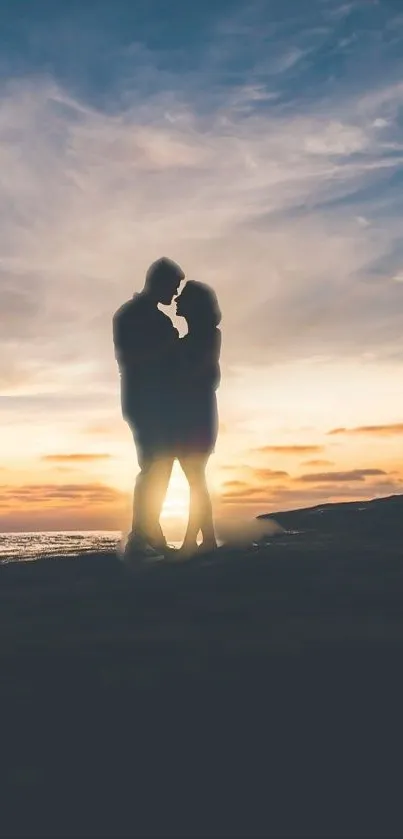 Romantic couple silhouette at sunset on beach.