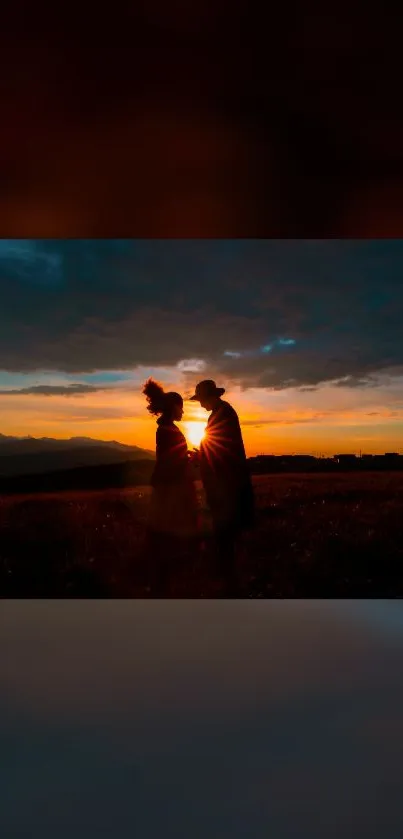 Silhouetted couple against a vibrant sunset.