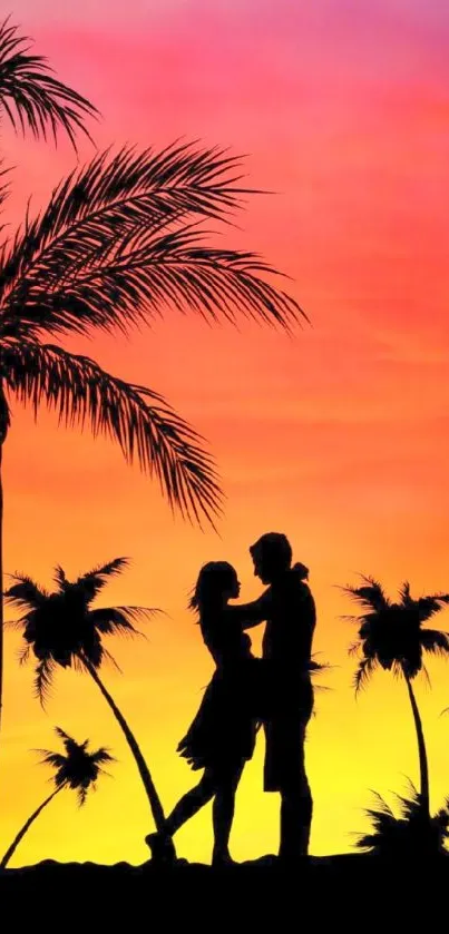 Silhouette of a couple under palm trees at tropical sunset.