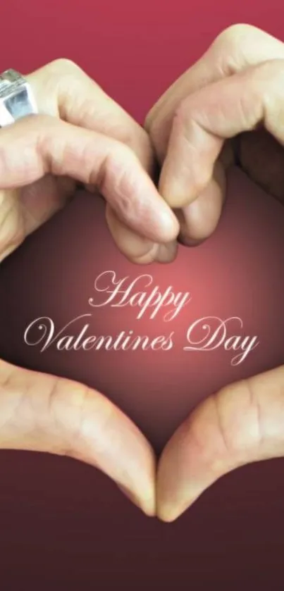 Hands forming a heart with Happy Valentine's Day text on pink background.