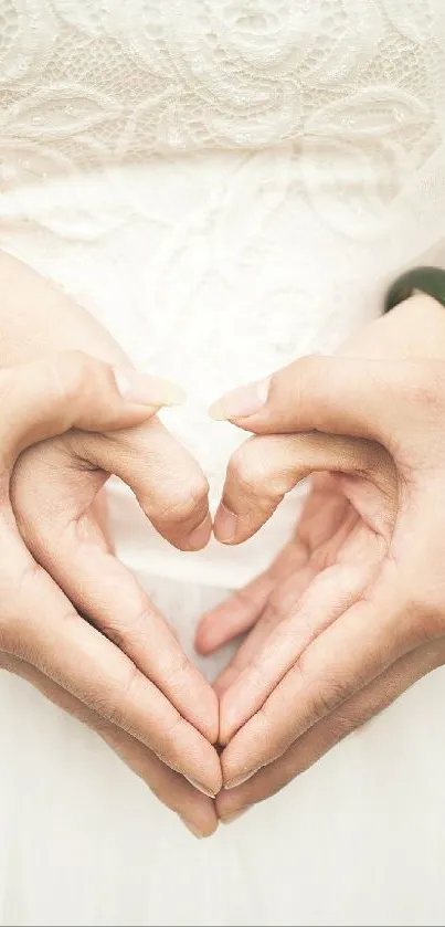 Bride and groom forming heart with hands in romantic close-up.