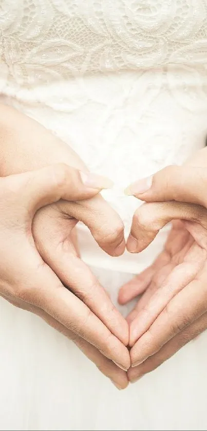 Bride and groom create heart with hands in elegant wedding scene.