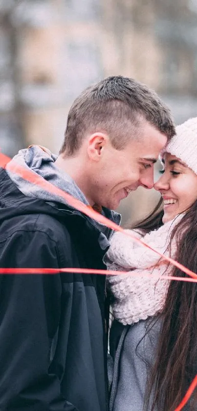 Couple embracing with heart balloons in winter.