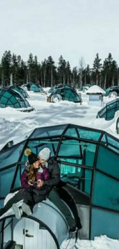 Couple enjoying a winter igloo escape in snowy landscape.