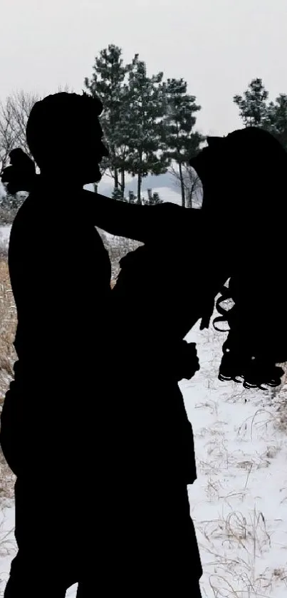 Silhouette of a couple embracing in a snowy winter landscape.