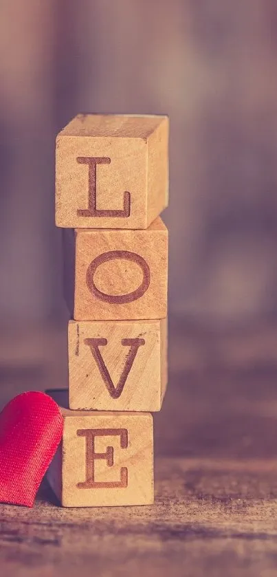 Wooden blocks spelling LOVE with red heart.