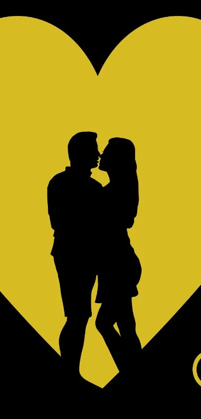 Silhouette couple kissing in front of a large yellow heart.