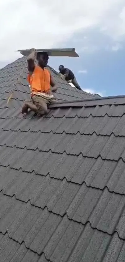 Workers installing roof tiles under open sky.