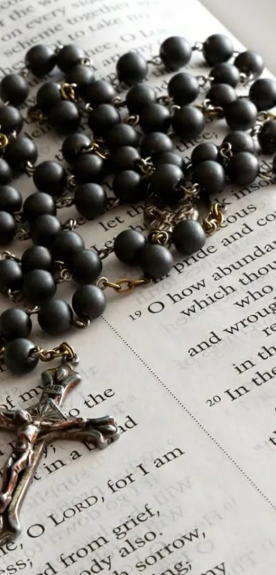 Rosary beads resting on an open Bible page.