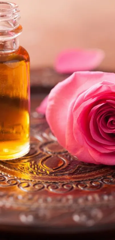 Pink rose and essential oil on an ornate plate.