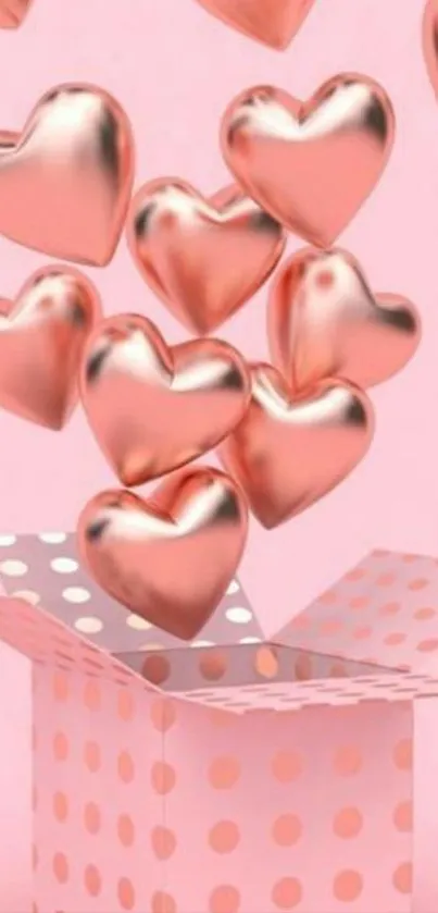 3D rose gold hearts float from polka dot pink box.