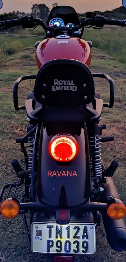 Royal Enfield motorcycle at sunset viewed from the rear.