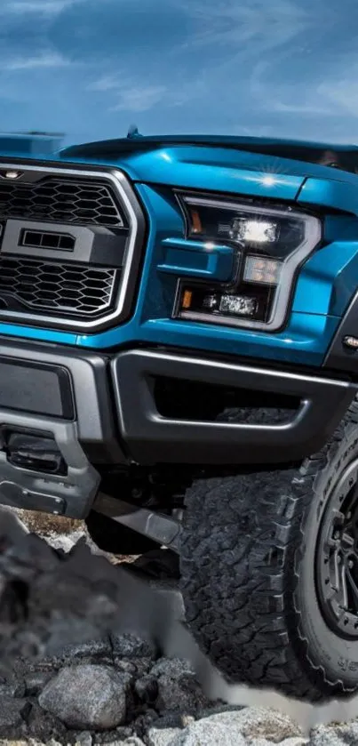 Rugged blue off-road truck on rocky terrain in mobile wallpaper image.